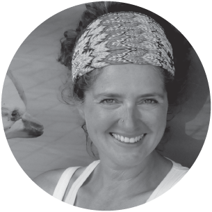 a woman wearing a hat and smiling at the camera