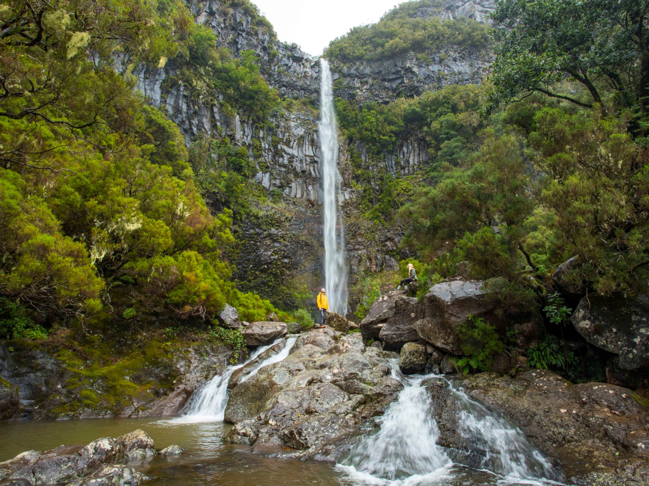 a large waterfall over some water