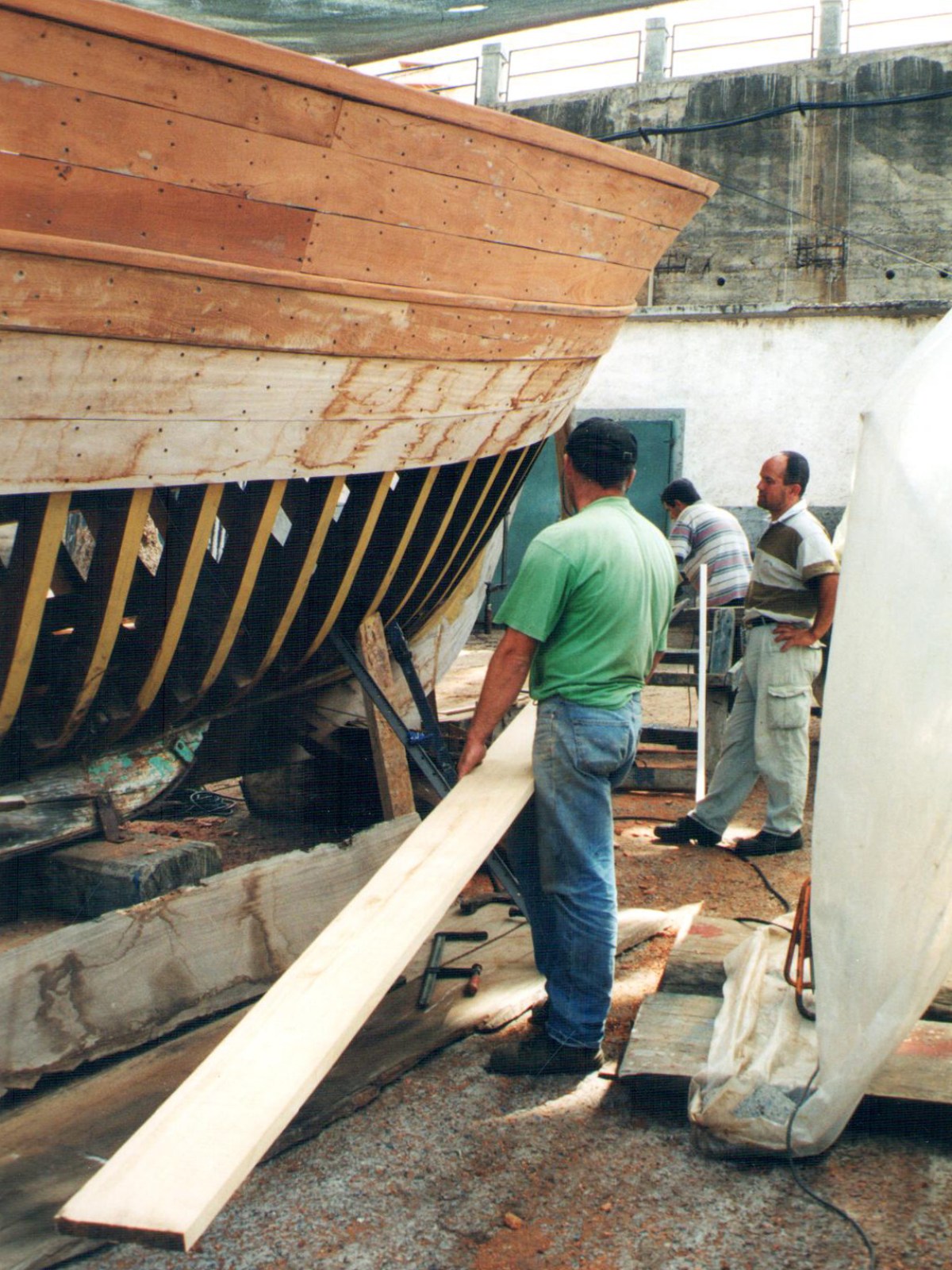a man standing next to a boat